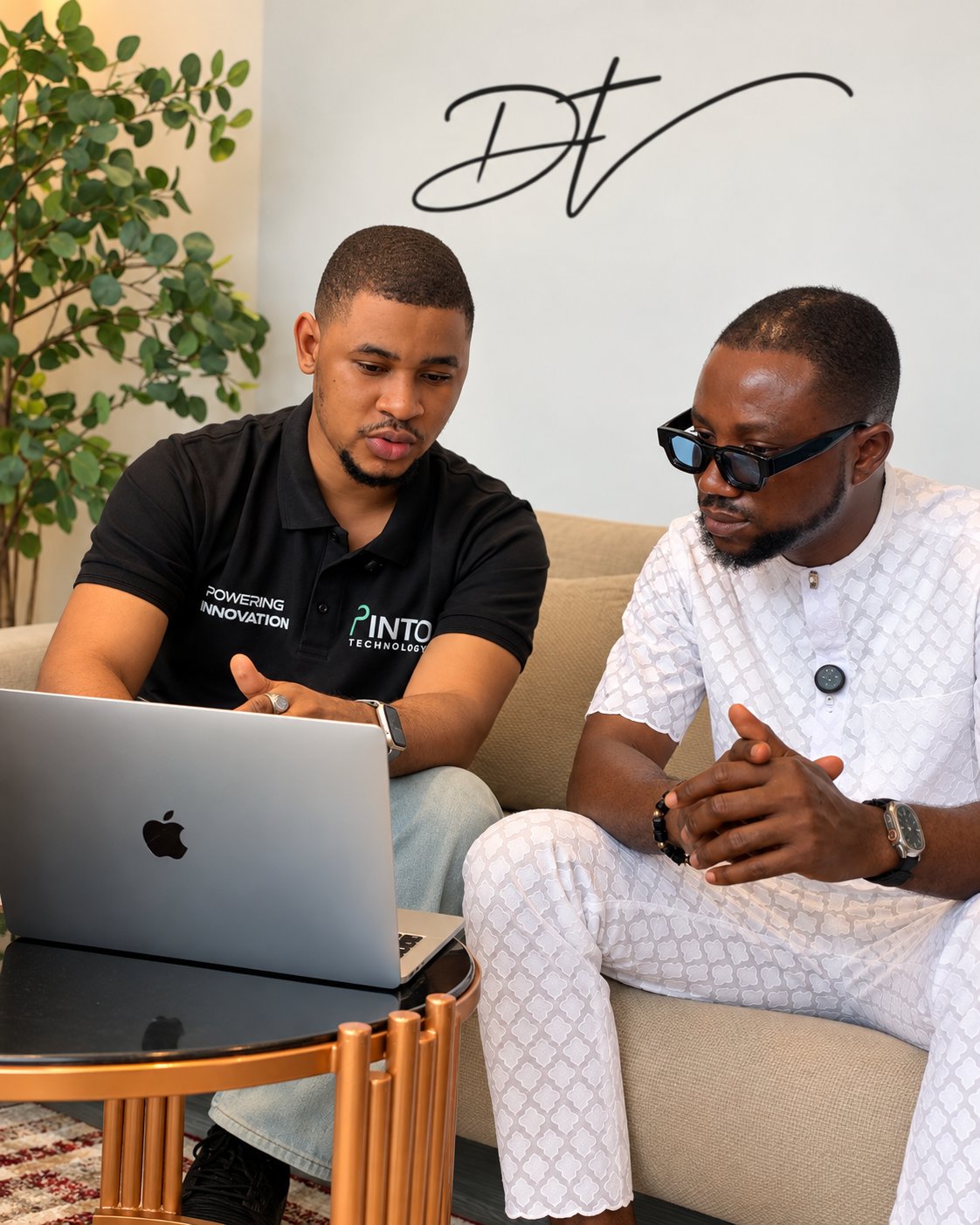 Two people reviewing a laptop during a Pintop Technologies business discussion